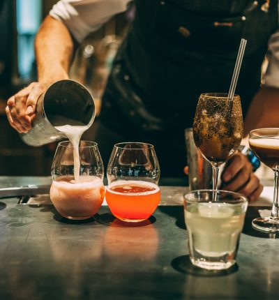 Bartender making alcoholic cocktail, summer cocktail in bar