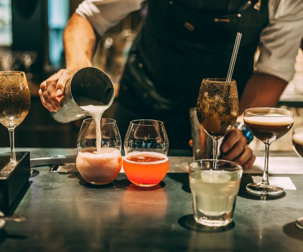 Bartender making alcoholic cocktail, summer cocktail in bar