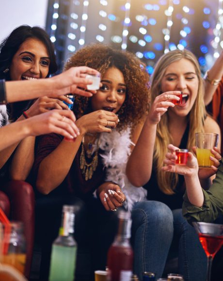 Cropped shot of a group of friends having shots together at a party